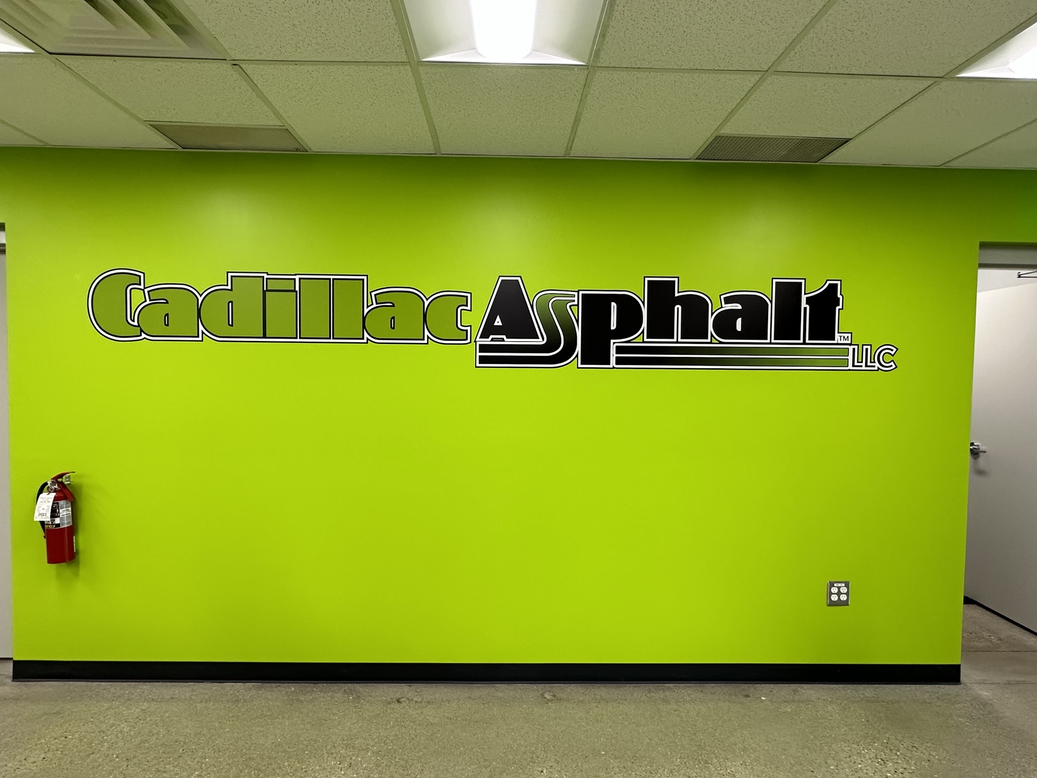 Large Cadillac Asphalt wall graphic on a bright green interior wall