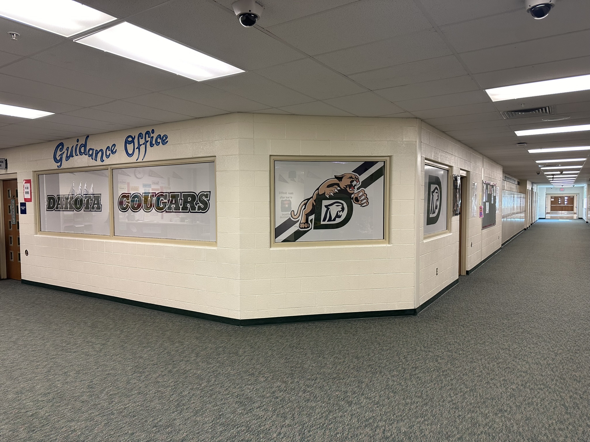 Dakota Cougars lettering and mascot graphics on guidance office windows