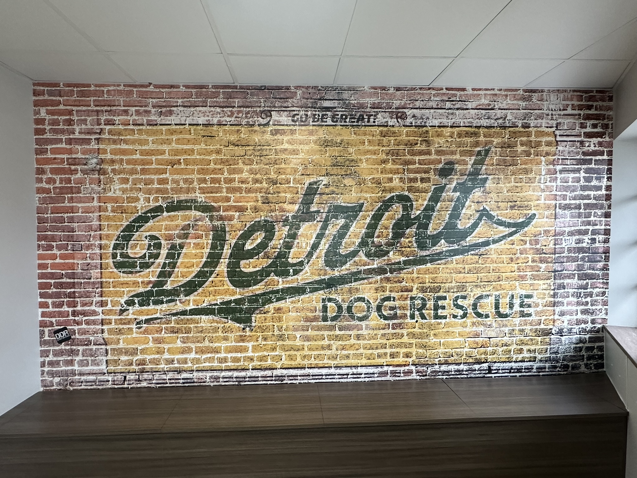 Detroit Dog Rescue wall mural with a distressed brick pattern