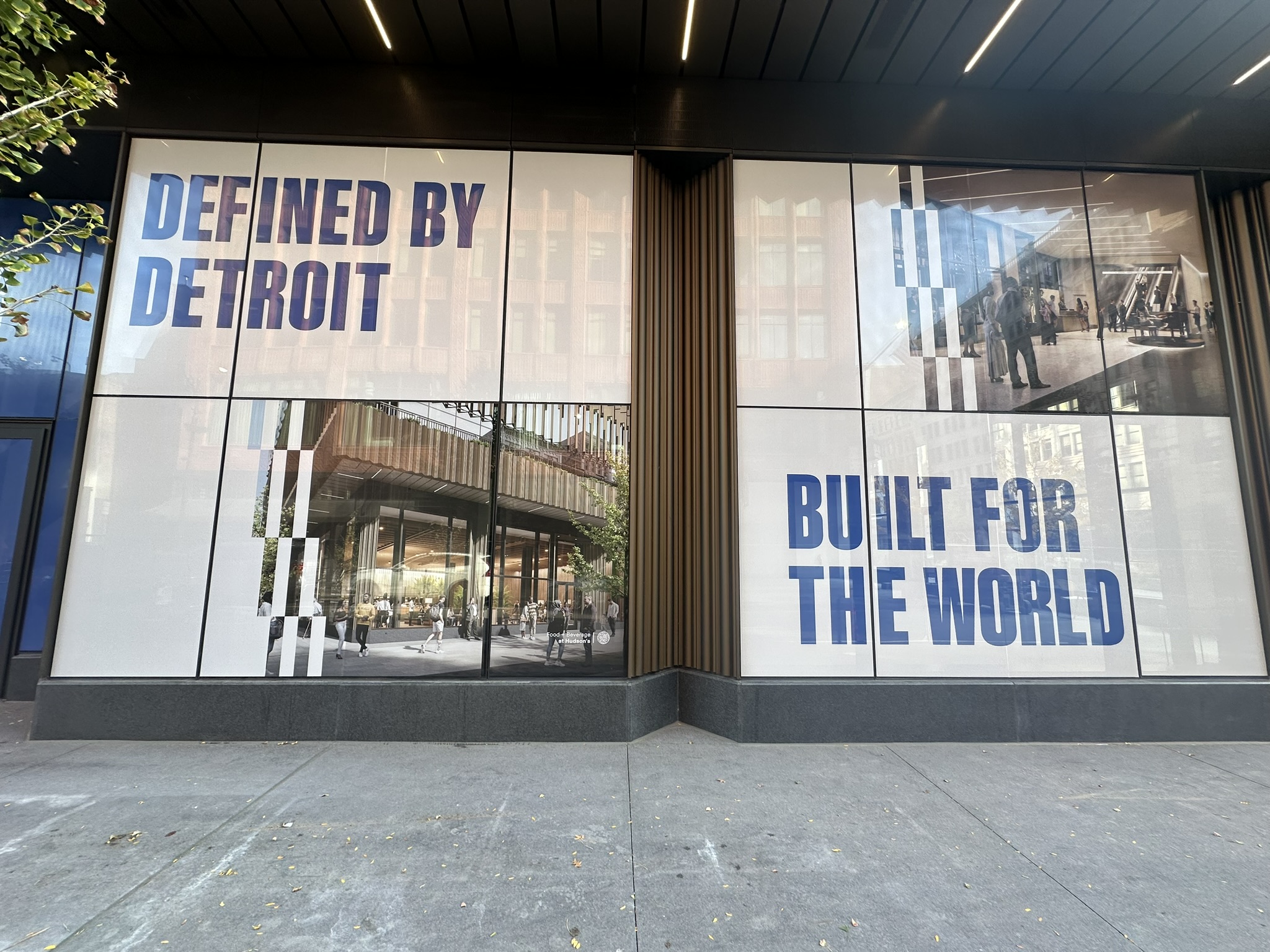 Building windows covered with architectural imagery and Defined by Detroit lettering
