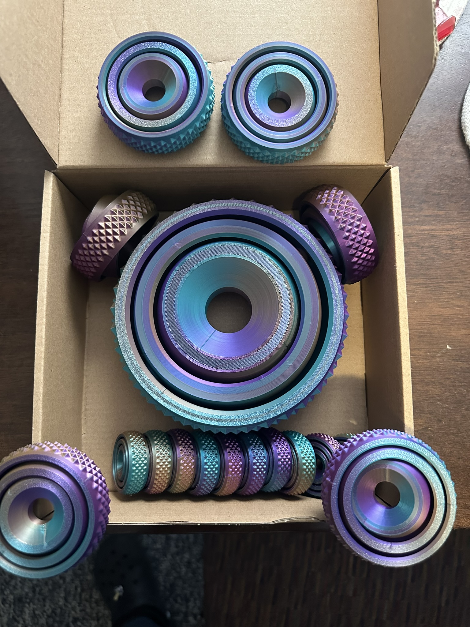 Purple and teal circular 3D prints in different sizes with textured edges