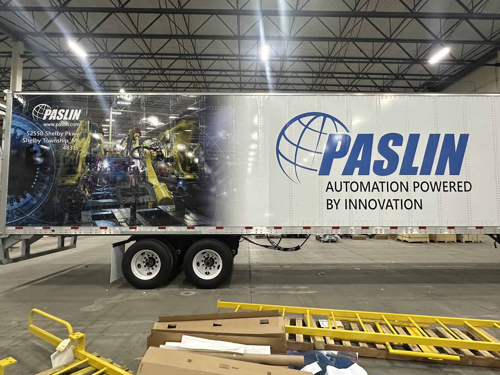 PASLIN branding and automation imagery across a commercial trailer